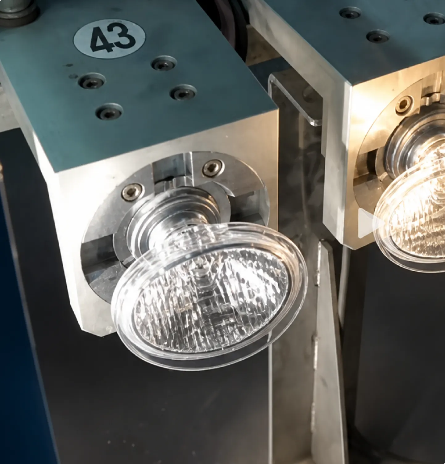 Vehicle light lens being formed and inspected during production