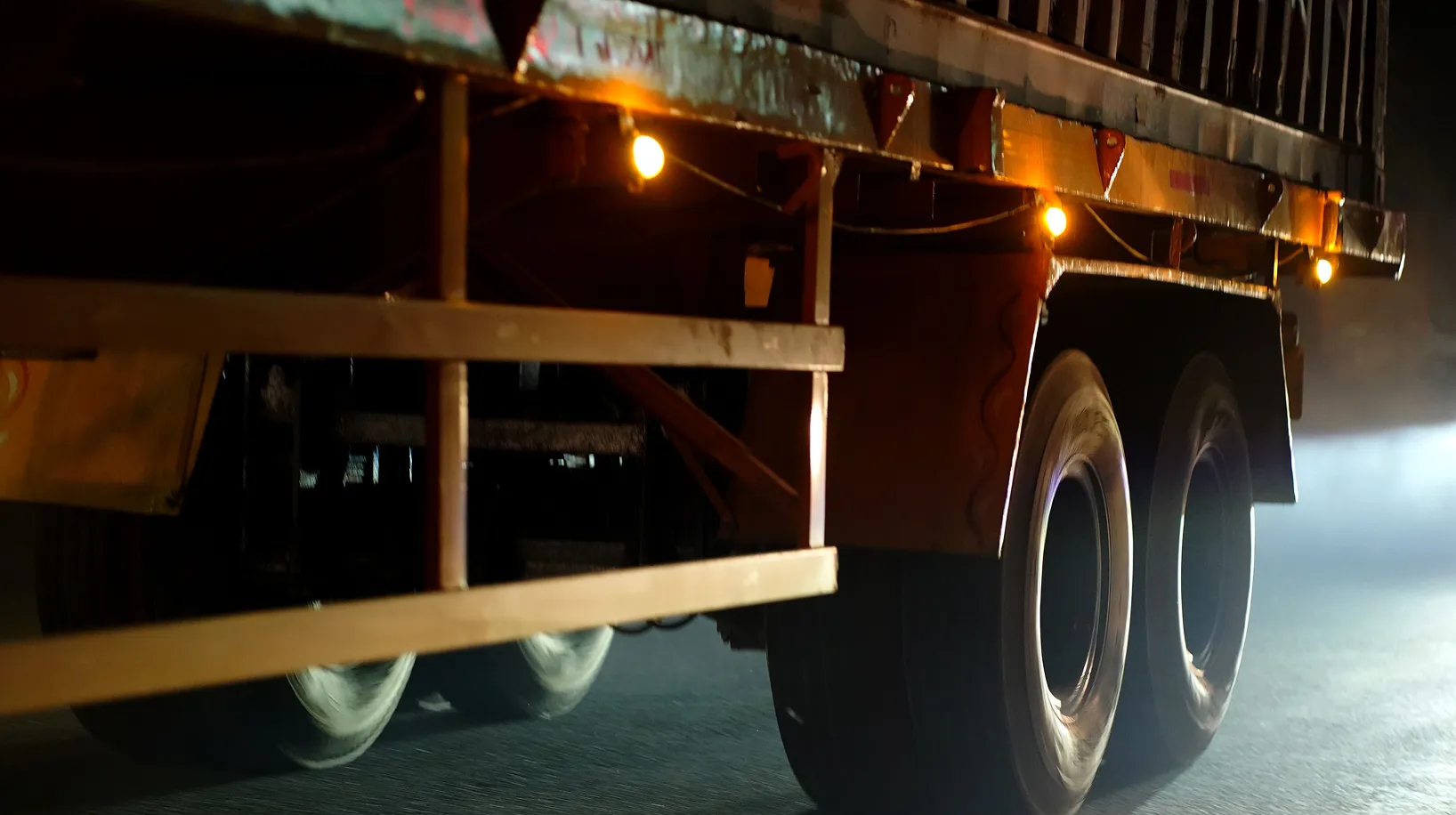 Bright red industrial tail lights installed beneath a vehicle